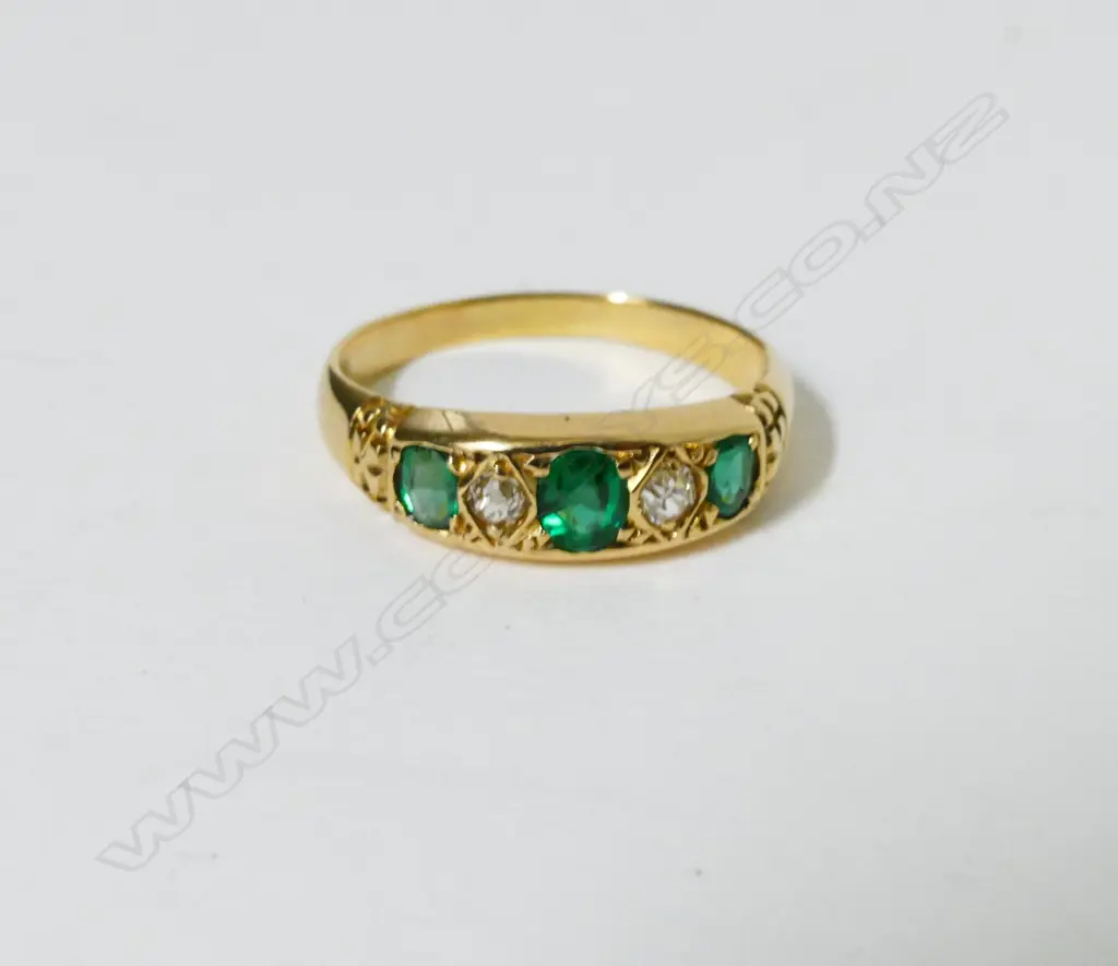 An 18ct. gold emerald and diamond ring Image 1++