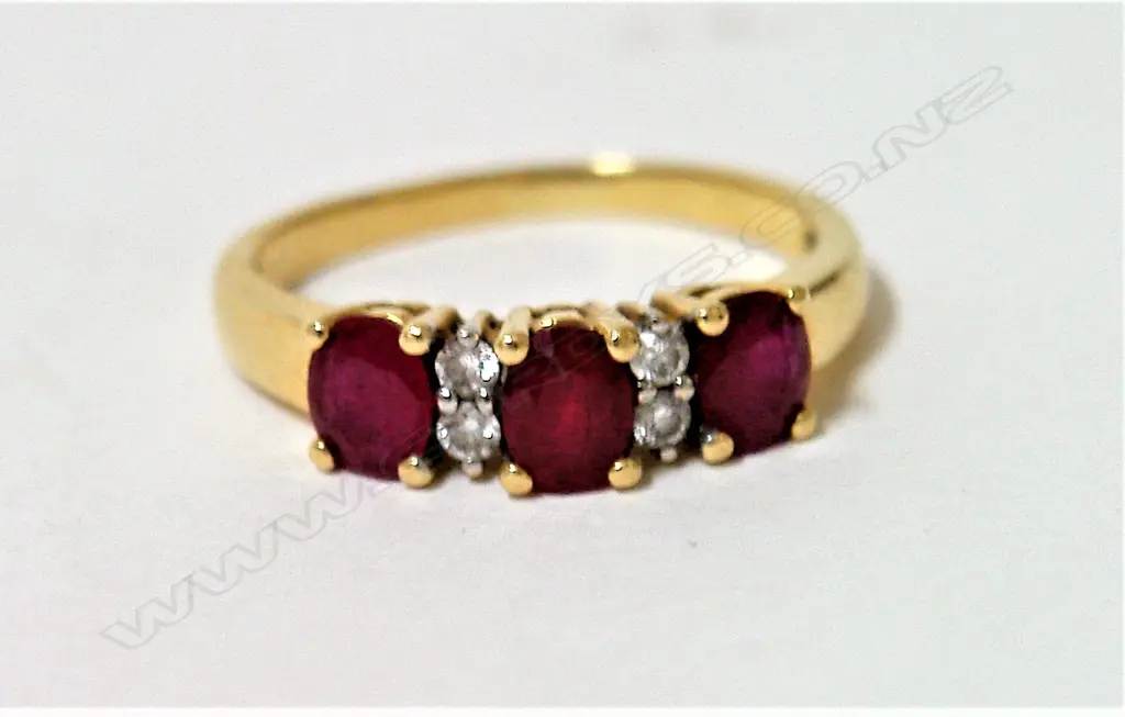 An estate 18ct. yellow gold ruby and diamond bridge ring Image 1++