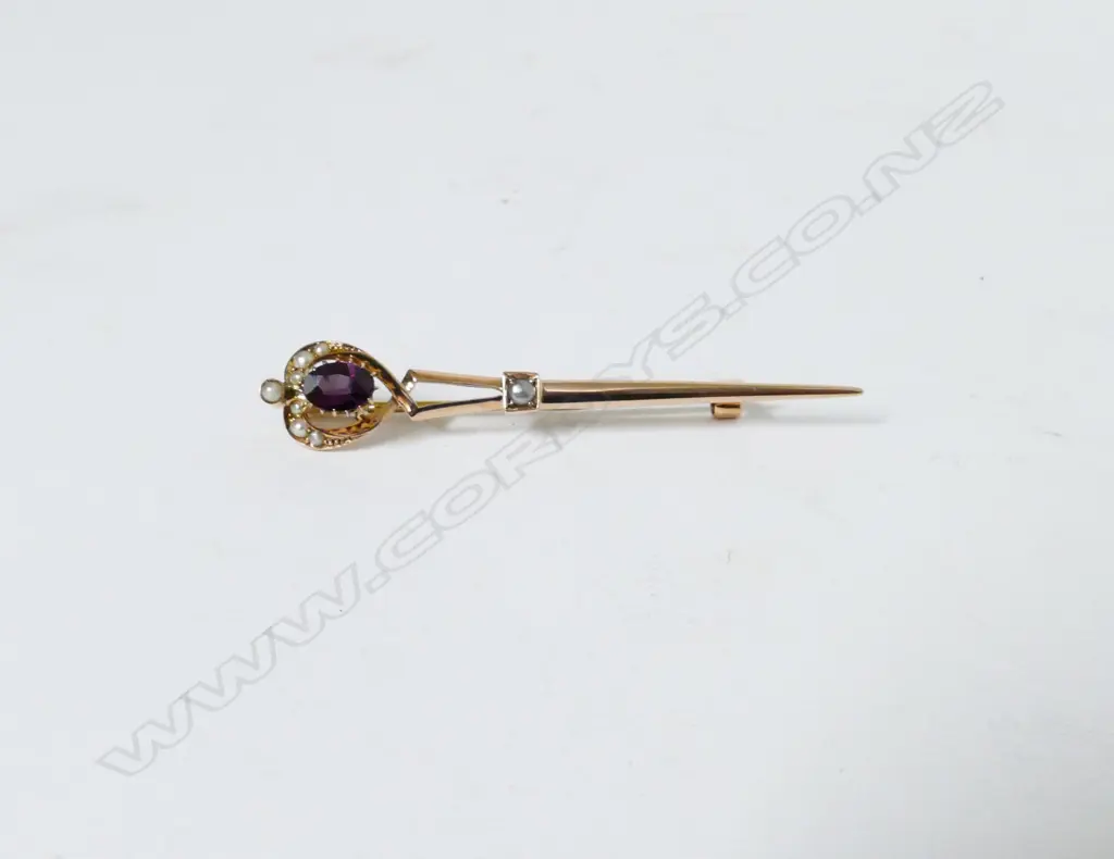 A 9ct. gold amethyst and seed pearl set sword brooch Image 1++