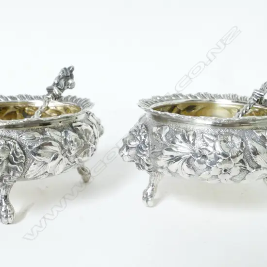 A pair of American silver cauldron salt cellars and a pair of Victorian silver salt spoons