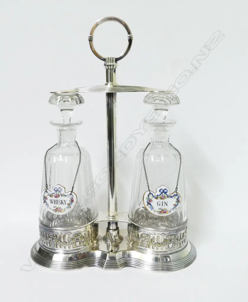 An Edwardian silver plated two-decanter tantalus set Image 1++