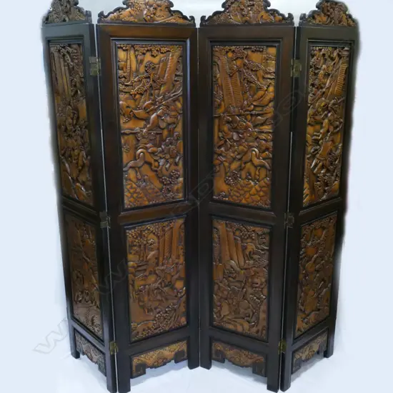 A four-fold carved wooden Oriental screen
