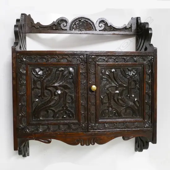 A small oak wall cabinet