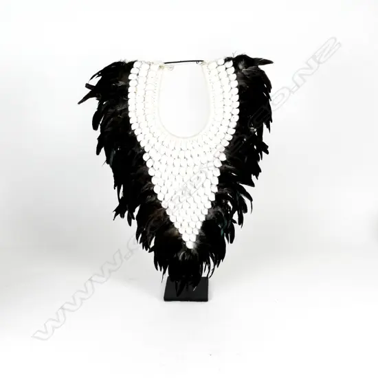 A contemporary artistic collar of shells and feathers