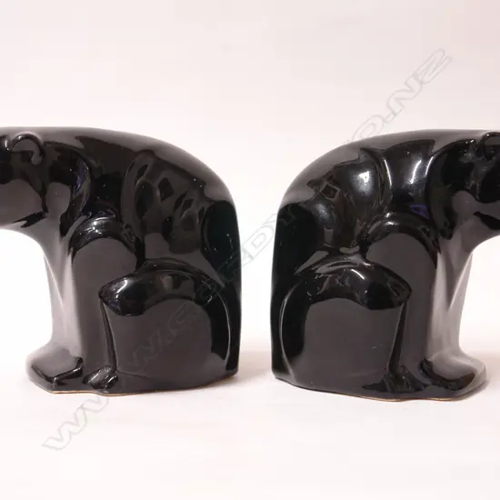 A pair of rare early Crown Lynn black glazed polar bear bookends