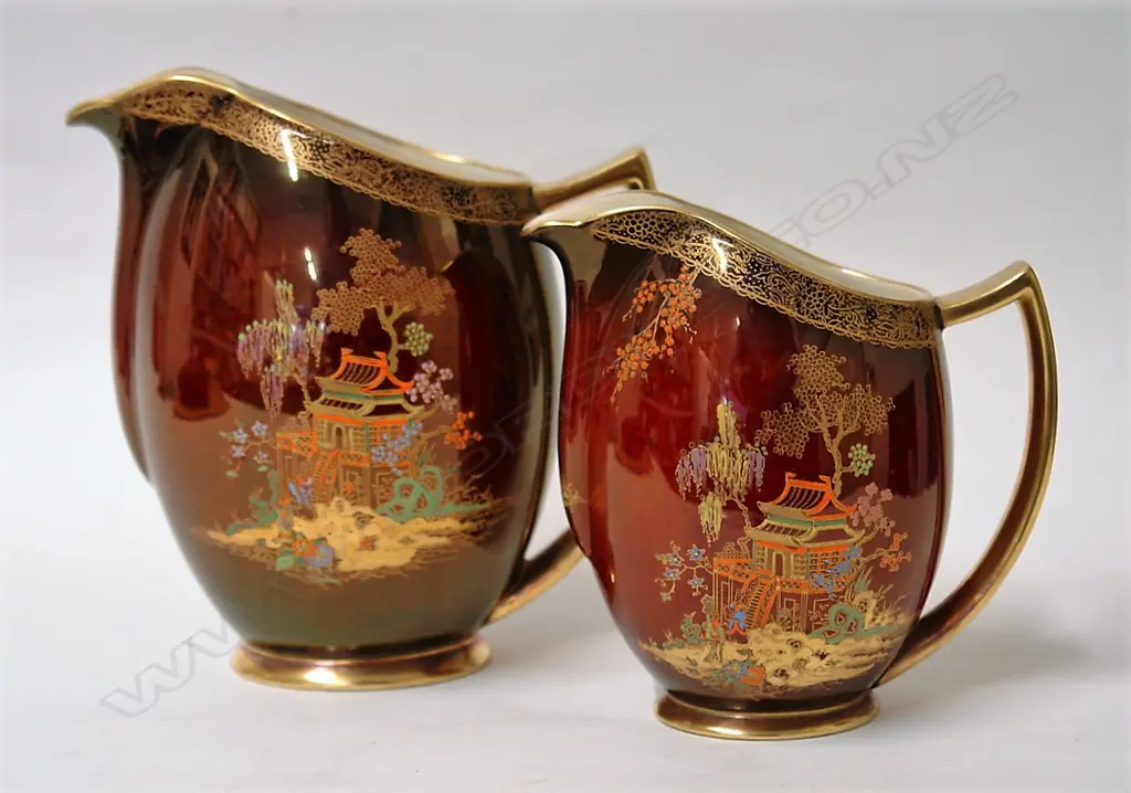 A graduated pair of Carlton Ware Rouge Royale Chinese pagoda decorated jugs Image 1++