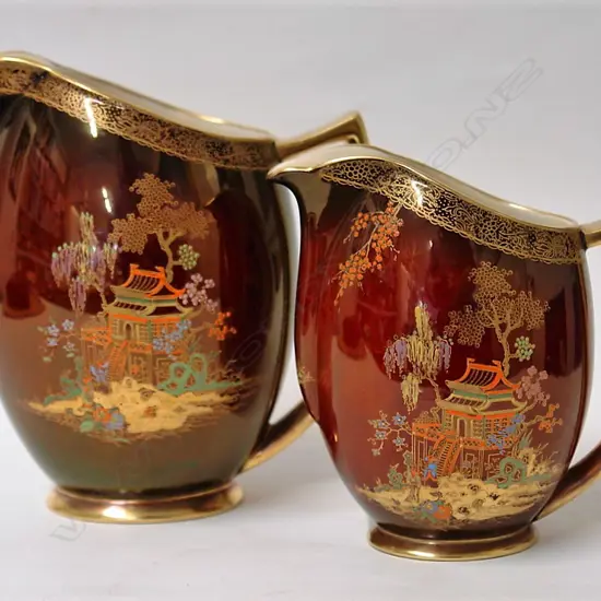 A graduated pair of Carlton Ware Rouge Royale Chinese pagoda decorated jugs