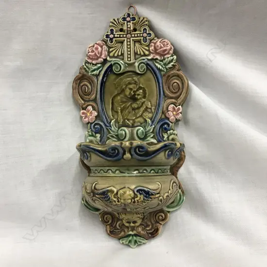 A vintage majolica holy water font