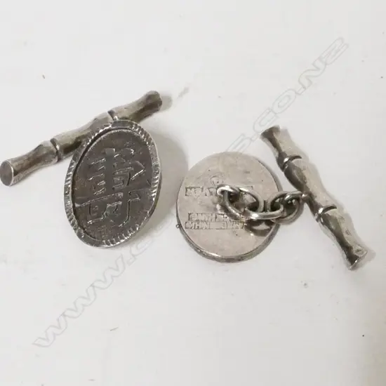A pair of Chinese silver cuff links