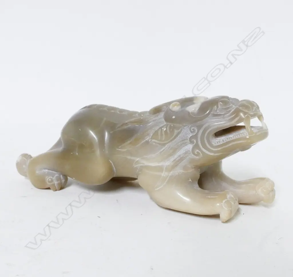 A pale caramel coloured jade carved temple dog Image 1++