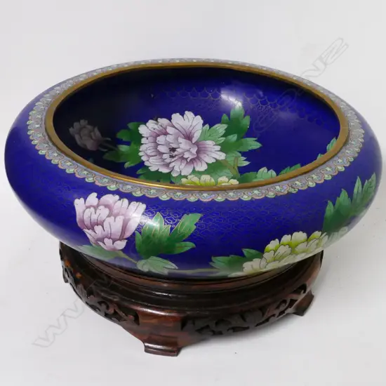 A large Chinese cloisonnè bowl on wooden stand