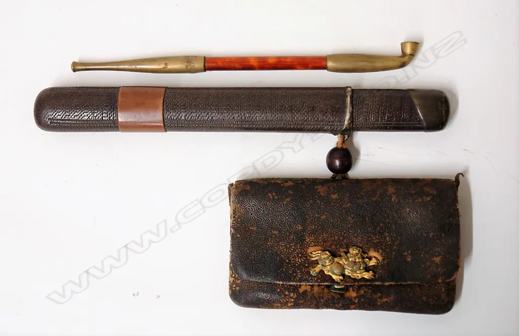 An old Japanese smoker's pipe in a container with a leather pouch and ojimi bead Image 1++