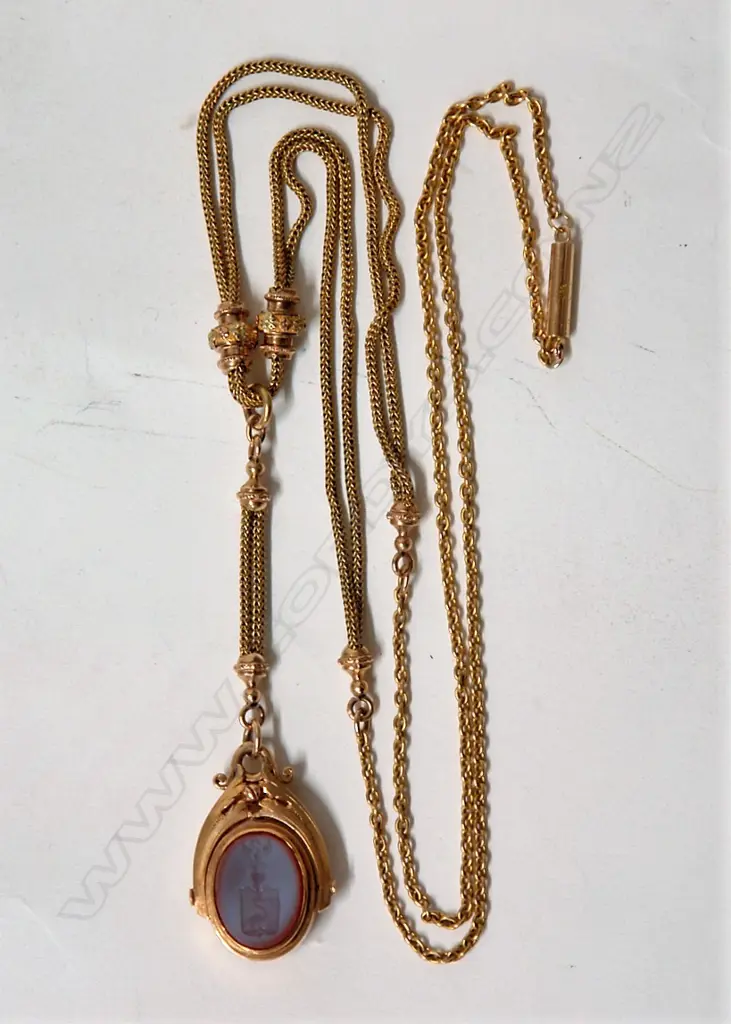 A Victorian 15ct. yellow gold double chain length with fob swivel pendant Image 1++
