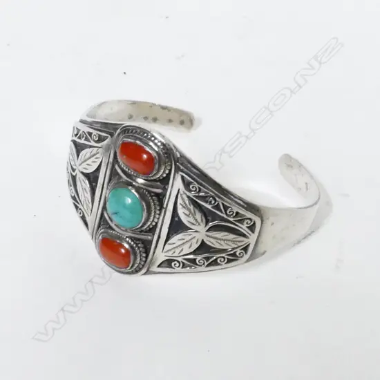 A Navajo silver coral and turquoise cuff