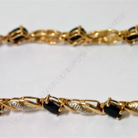 A lady's 9ct. yellow gold sapphire and diamond set bracelet