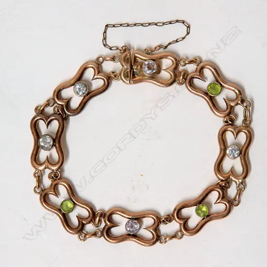 A c.1900 rose gold peridot and white sapphire bracelet