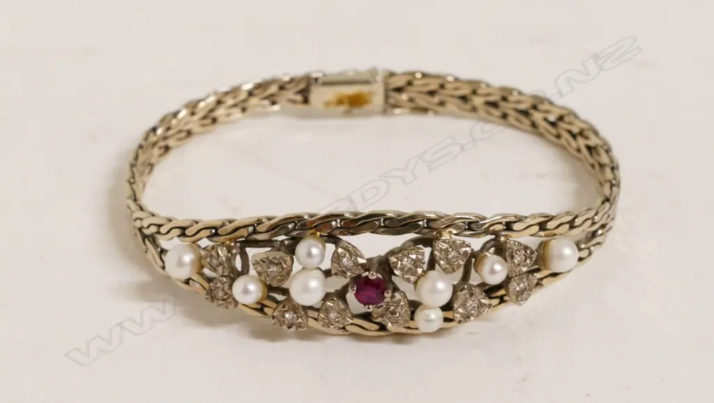 A 14ct. white gold pearl diamond and ruby bracelet Image 1++