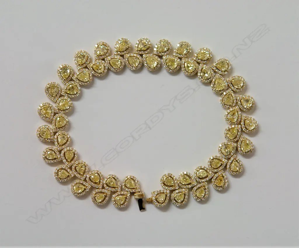 A stylish lady's 18ct. yellow gold white and fancy yellow diamond bracelet Image 1++