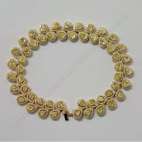 A stylish lady's 18ct. yellow gold white and fancy yellow diamond bracelet