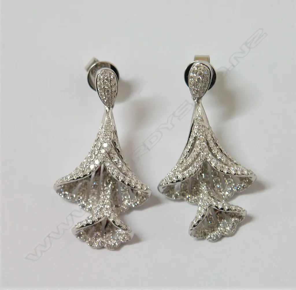 A pair of elegant modern lady's 18ct. white gold and diamond articulated bell flower earrings Image 1++