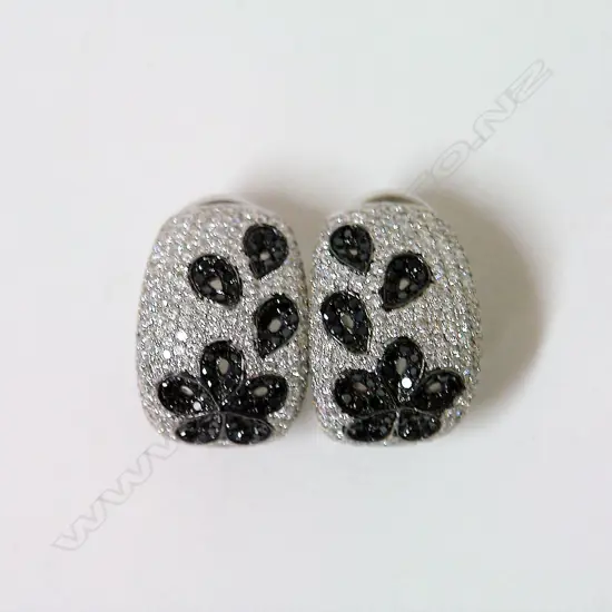 A pair of 18ct. lady's black and white diamond encrusted earrings