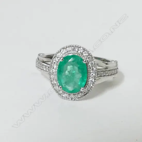 An 18ct. white gold emerald and diamond ring