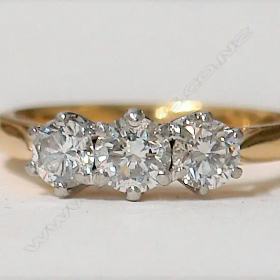 An estate 18ct. gold and three stone diamond ring