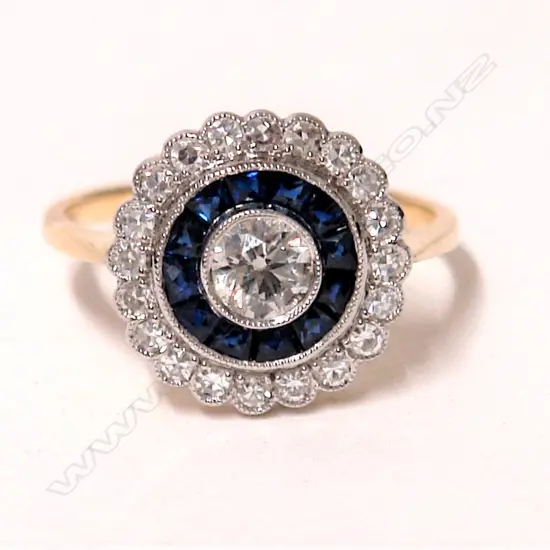 An 18ct. yellow and white gold Art Deco style diamond and sapphire cluster ring