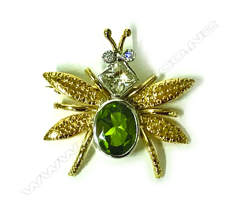 An 18ct. gold diamond and peridot bug brooch Image 1++
