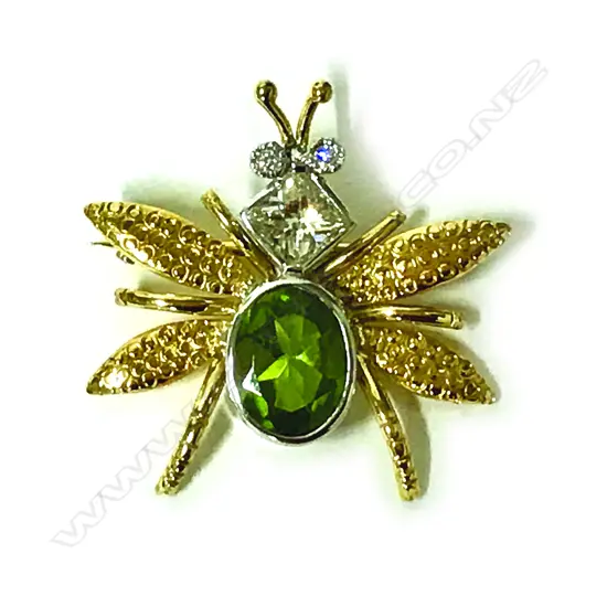 An 18ct. gold diamond and peridot bug brooch