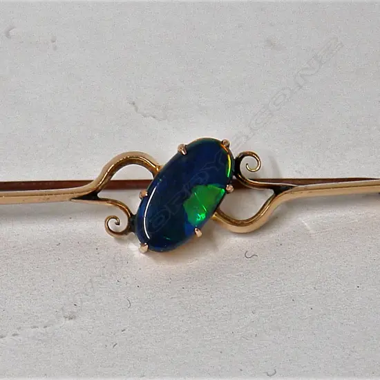A vintage natural bright dark toned opal and 15ct yellow gold brooch
