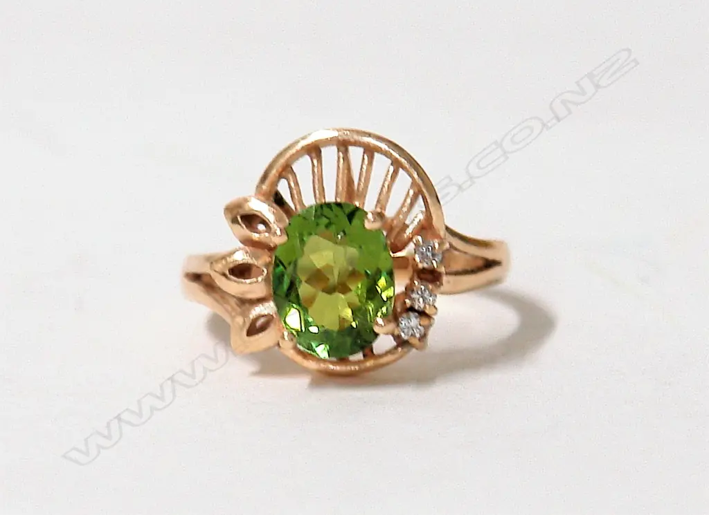 A lady's modern 9ct. gold and green topaz and diamond dress ring Image 1++