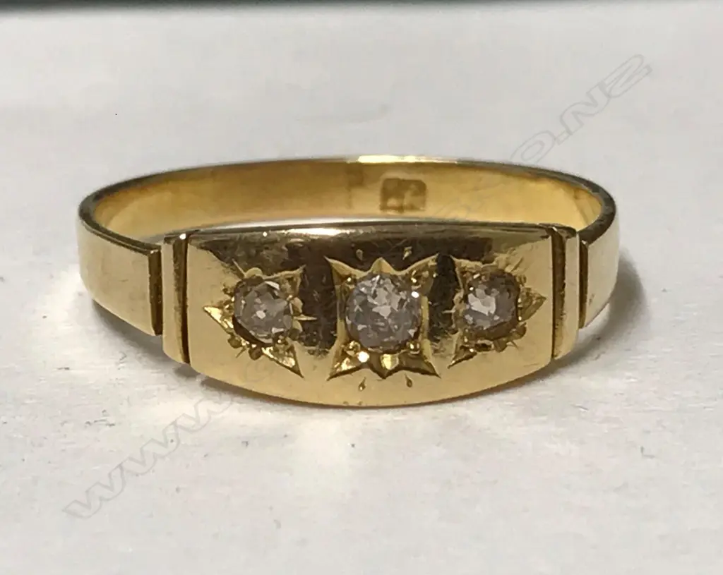 An 18ct. yellow gold and three stone diamond ring Image 1++
