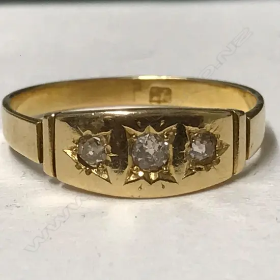 An 18ct. yellow gold and three stone diamond ring
