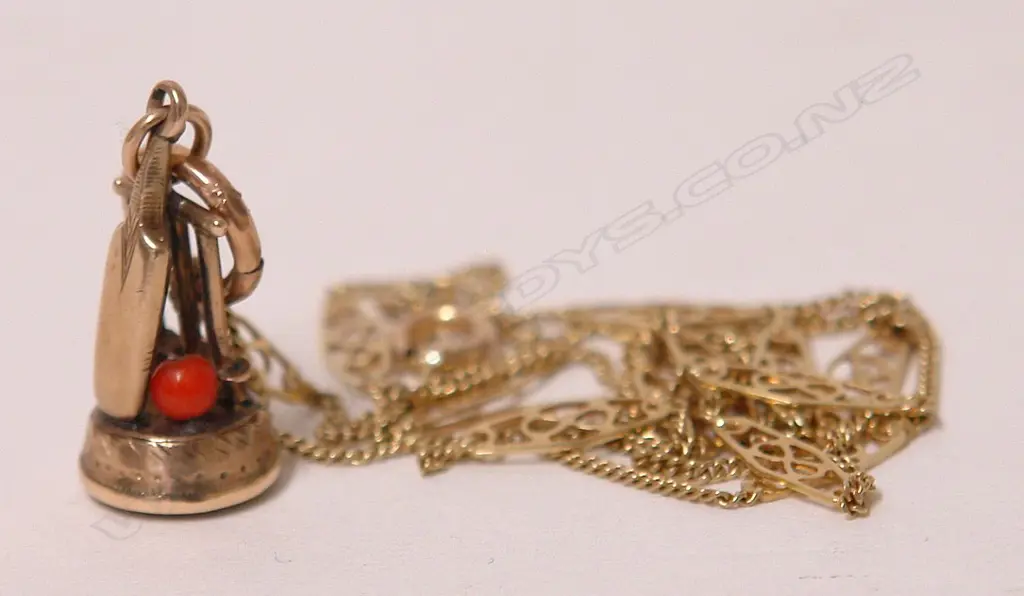 A 19thC gold cricket themed fob seal on a 14ct. yellow gold chain Image 1++