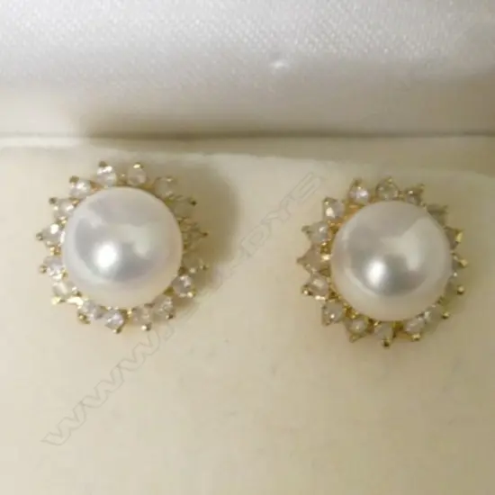 A pair of 9ct. gold pearl and diamond stud earrings