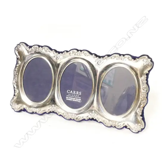 A modern silver triple photo frame