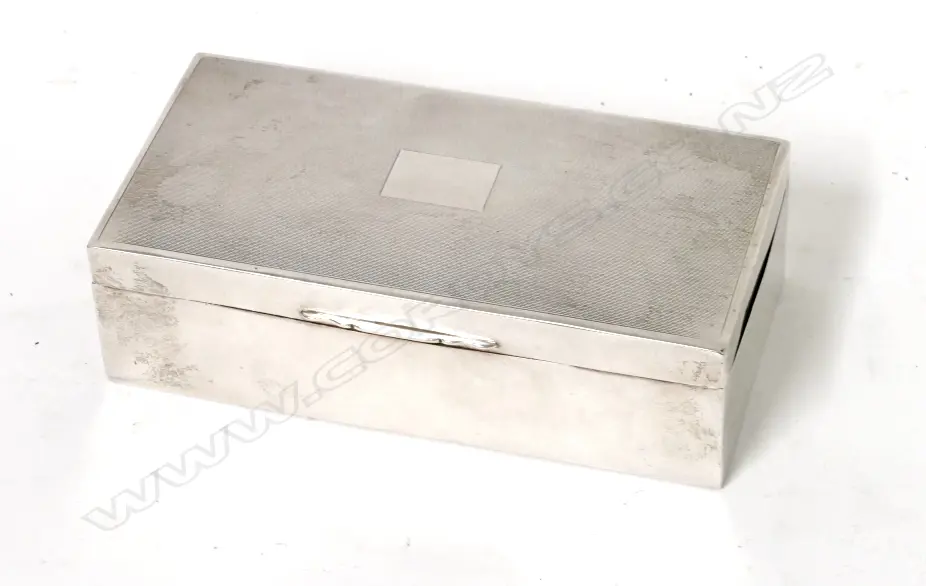 A silver cigarette box of oblong shape with engine turned lid Image 1++