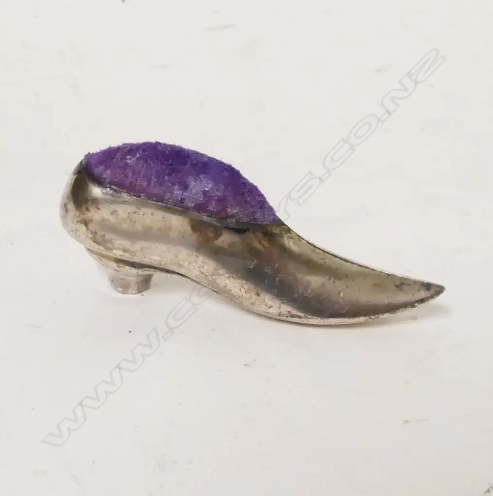 A silver shoe pin cushion Image 1++