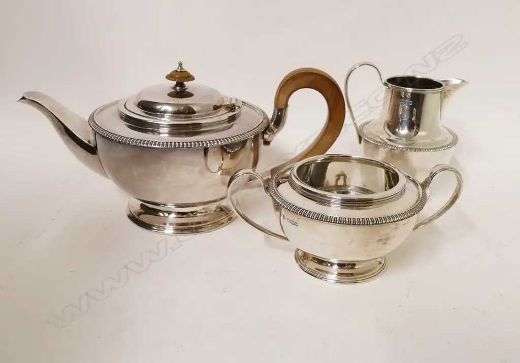 A silver three-piece tea set Image 1++