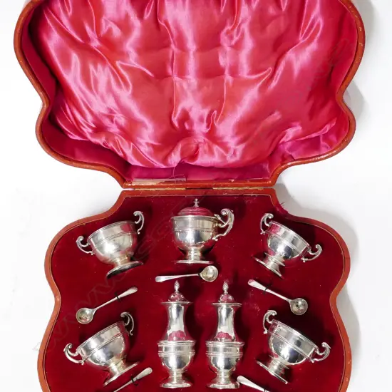 A seven piece Edwardian silver condiment set