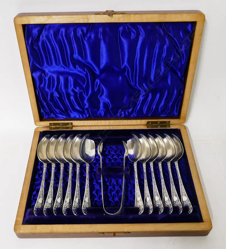 A walnut cased set of 12 silver teaspoons and a pair of sugar tongs Image 1++