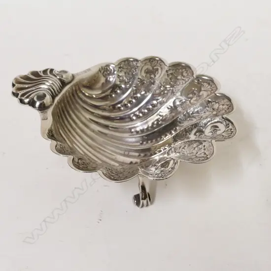 A silver scalloped shaped dish