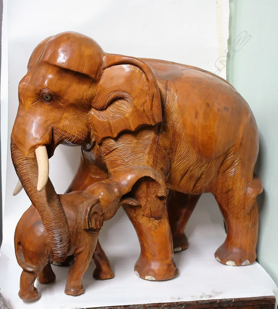 A large carved teak elephant with child Image 1++
