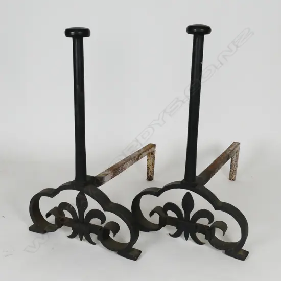 A large and impressive pair of cast iron fire dogs