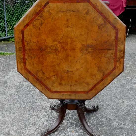 A Victorian burr walnut octagonal tilt-top supper table