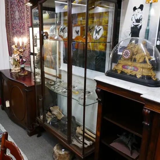 A vintage glass display cabinet