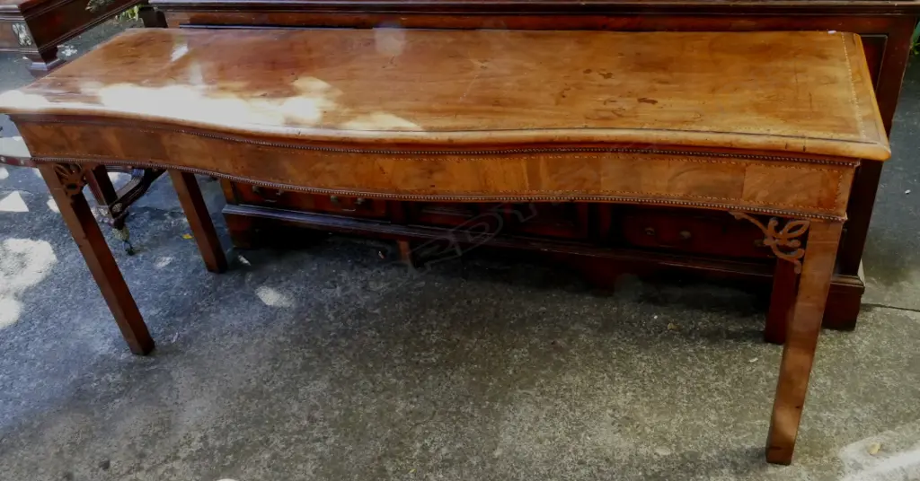 A Georgian walnut serpentine side table with cross banding and herringbone stringing Image 1++