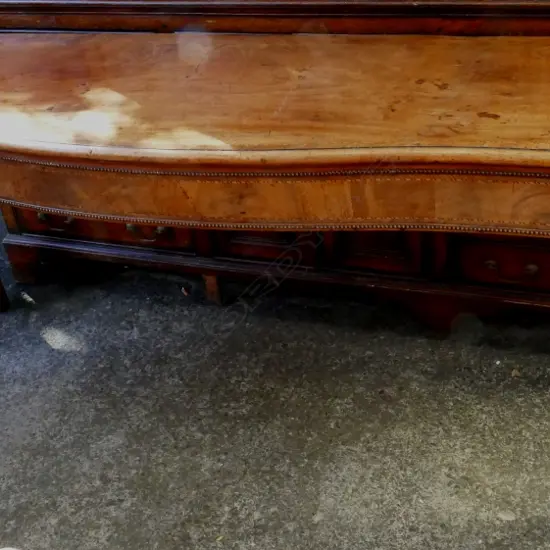 A Georgian walnut serpentine side table with cross banding and herringbone stringing