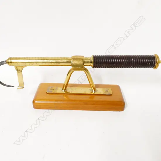 A brass extendable fishing gaff